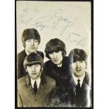 The Beatles Signed Photograph signed in blue ink to the front 'Paul, Ringo, George, John' on a black