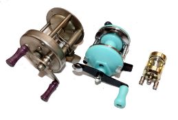 REELS: (3) An Abu Record 1500 multiplier reel in fine condition, twin purple handles, model "C",