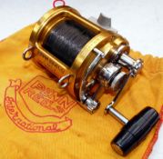 REEL: Penn International 12T multiplier reel, gold finish, lever drag with pre-set, rod saddle