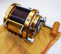 REEL: Penn International 50 multiplier reel, gold finish, lever drag with pre-set, rod saddle clamp,