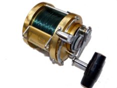 REEL: Penn International 50 multiplier reel, gold finish, lever drag with pre-set, rod saddle clamp,