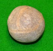 Smooth stone ball with uneven areas - the size of a golf ball