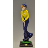 Fine hand painted figure of an early 1900's lady golfer - putting in long flowing skirt by