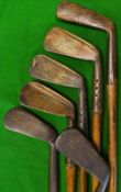 3x Hawkins never rust flanged bottom irons 2x mid-irons and a mashie all showing the leaping stag