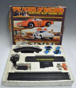 1980s The Dukes of Hazard Electric Slot Racing Set includes two cars, two controllers, mains