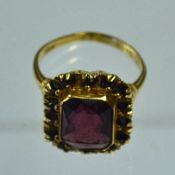 10K Gold Garnet and Amethyst Ring a garnet surrounded by amethysts, 3g, with PSCO stamped to the