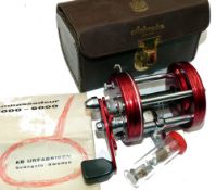 REEL: Abu Ambassadeur 6000 multiplier reel, 3 screw red grooved end plates, level wind, free