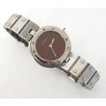 LADY'S CARTIER STAINLESS STEEL WRISTWATCH  
with a circular claret coloured dial and quartz