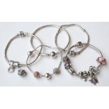 FIVE PANDORA SILVER BRACELETS three with charms (5)