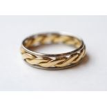 TWO TONE EIGHTEEN CARAT GOLD RING with rope twist decoration, ring size J-K, approximately 2.