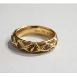 DIAMOND SET EIGHTEEN CARAT GOLD RING with relief decoration overall, total weight approximately 7.