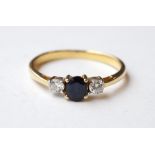 SAPPHIRE AND DIAMOND THREE STONE RING in unmarked high carat gold,