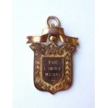 'THE LOWRIE MEDAL' nine carat gold school medal,