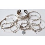 SELECTION OF ELEVEN SILVER BRACELETS AND BANGLES of various designs and sizes,