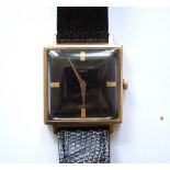 LADIES REPLICA PATEK PHILLIPPE 9CT GOLD WRISTWATCH with a signed square black face with baton