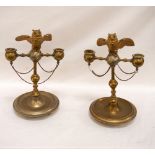 PAIR OF CONTINENTAL BRASS CANDLESTICKS the owl finial vestas with lift up heads perched on a