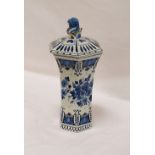 DELFT HEXAGONAL LIDDED VASE with a lion finial above a shaped body decorated with flowers,