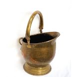 BRASS HELMET COAL SCUTTLE with a swing over handle,