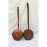 TWO 19th CENTURY COPPER WARMING PANS each with pierced decorated lift up lids on turned tapering