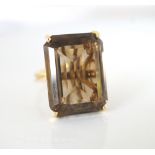 LARGE SMOKY QUARTZ SINGLE STONE RING the emerald cut quartz on eighteen carat gold shank and fancy