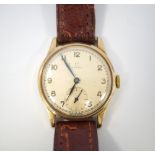 1950's GENTLEMAN'S 'OMEGA' NINE CARAT GOLD CASED WRISTWATCH with Arabic numerals and subsidiary