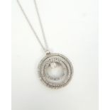 ATTRACTIVE DIAMOND SET PENDANT the central round brilliant cut diamond approximately 0.