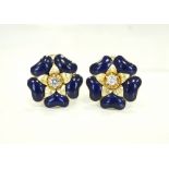 DIAMOND AND BLUE ENAMEL EARRINGS in the form of flower heads,