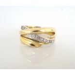 EGYPTIAN EIGHTEEN CARAT GOLD DRESS RING with clear gemstones to the twisted and pierced setting,