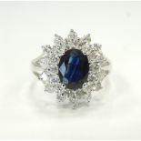 SAPPHIRE AND DIAMOND CLUSTER RING the central oval cut sapphire approximately 1.