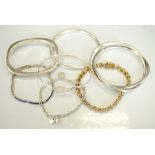 SELECTION OF SILVER BRACELETS AND BANGLES of various designs including a stone set silver gilt