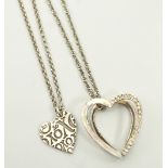 UNMARKED SILVER HEART PENDANT decorated with 'X's and 'O's on silver chain;