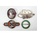 FOUR SILVER BROOCHES comprising a hardstone set unmarked silver brooch of entwined form;