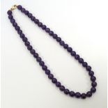 AMETHSYT BEAD NECKLACE with nine carat gold clasp,