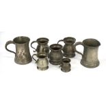 SEVEN VARIOUS PEWTER TANKARDS of varying sizes, two with glass bases and all with scroll handles,