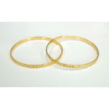 PAIR OF UNMARKED HIGH CARAT GOLD BANGLES with star motif decoration, total weight approximately 17.