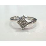 FOUR STONE PRINCESS CUT DIAMOND CLUSTER RING on nine carat white gold shank with twist setting,