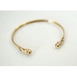 NINE CARAT GOLD BANGLE with ball finials, approximately 5.
