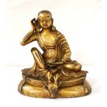 BRASS TIBETAN DEITY 'MILAREPA' seated wearing flowing robes with his right hand held to his ear and