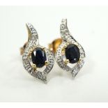 PAIR OF SAPPHIRE AND DIAMOND CLUSTER EARRINGS the central oval cut sapphire on each in diamond set
