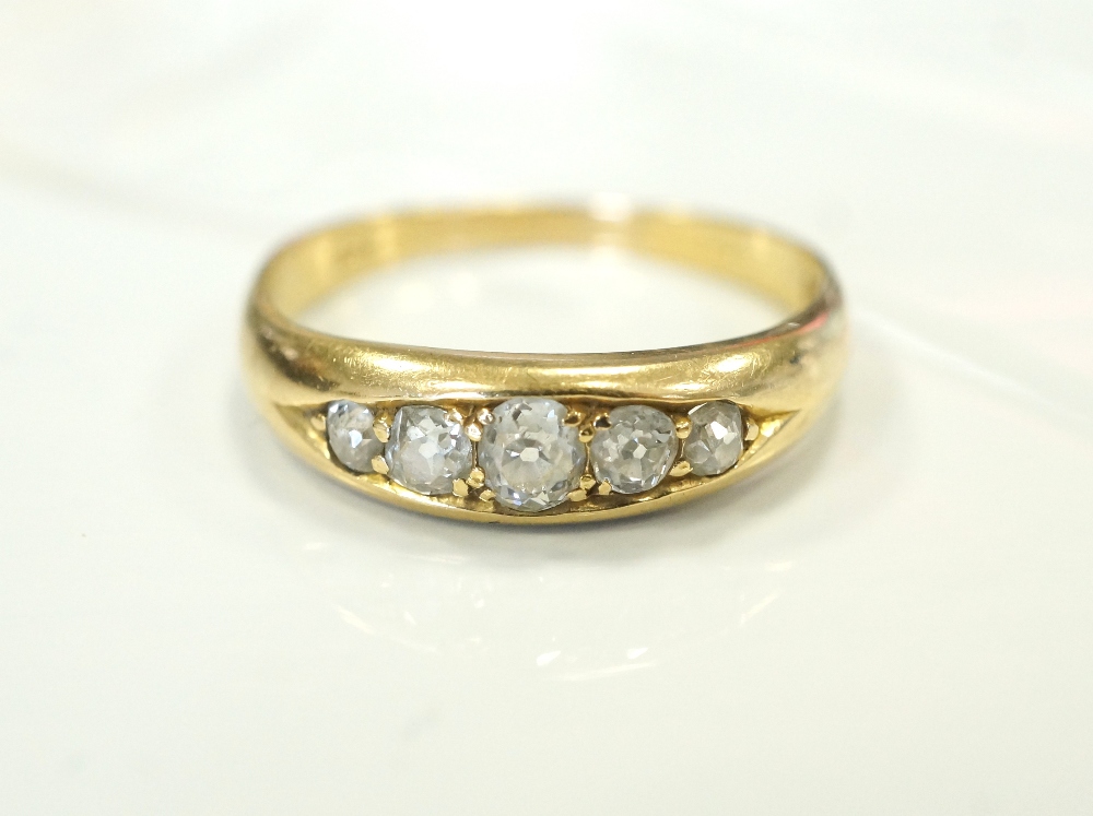 GRADUATED DIAMOND FIVE STONE RING on gold shank, the diamonds totalling approximately 0.