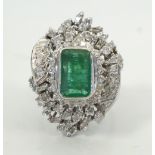 IMPRESSIVE EMERALD AND DIAMOND DRESS RING the central emerald approximately 3cts in ornate baguette