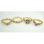 FOUR GEM SET SILVER GILT RINGS of various design,