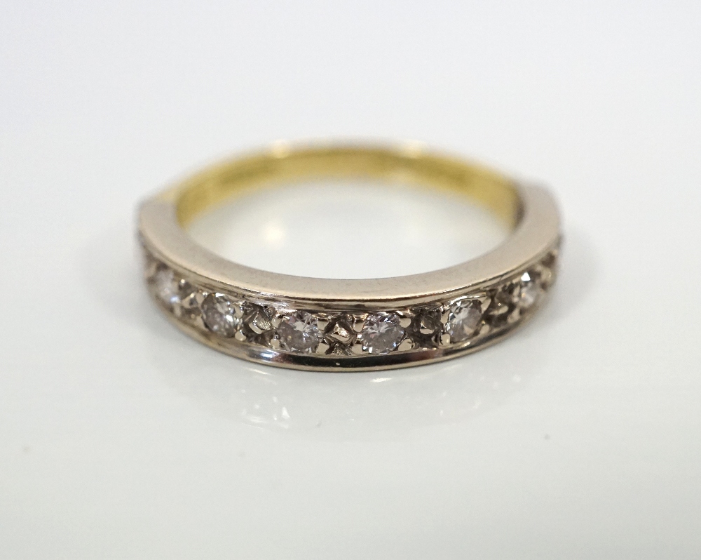 DIAMOND HALF ETERNITY RING in eighteen carat gold, the nine diamonds totalling approximately 0.