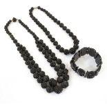 TWO VINTAGE CARVED JET BEAD NECKLACES one with double strand,