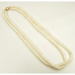 DOUBLE STRAND CULTURED PEARL NECKLACE with circular nine carat gold clasp,