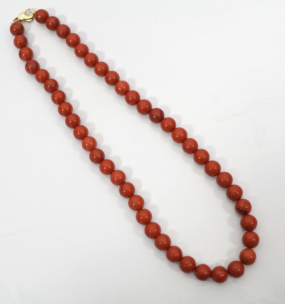 CORAL BEAD NECKLACE with nine carat gold clasp, 40cm long and total weight approximately 39.