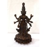 GILT BRONZE DEITY 'AVALOKITESHVARA' with her eleven heads and her hands outstretched and praying,