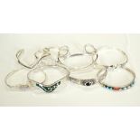 SELECTION OF EIGHT SILVER BANGLES of various designs including stone set examples (8)