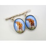PAIR OF SILVER AND ENAMEL GOLFING CUFFLINKS the two oval enamel panels depicting a golfer
