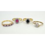 FOUR GEM SET SILVER GILT RINGS of various designs,